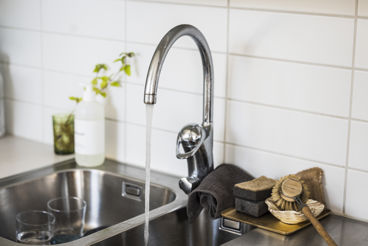 Tap water running in modern kitchen